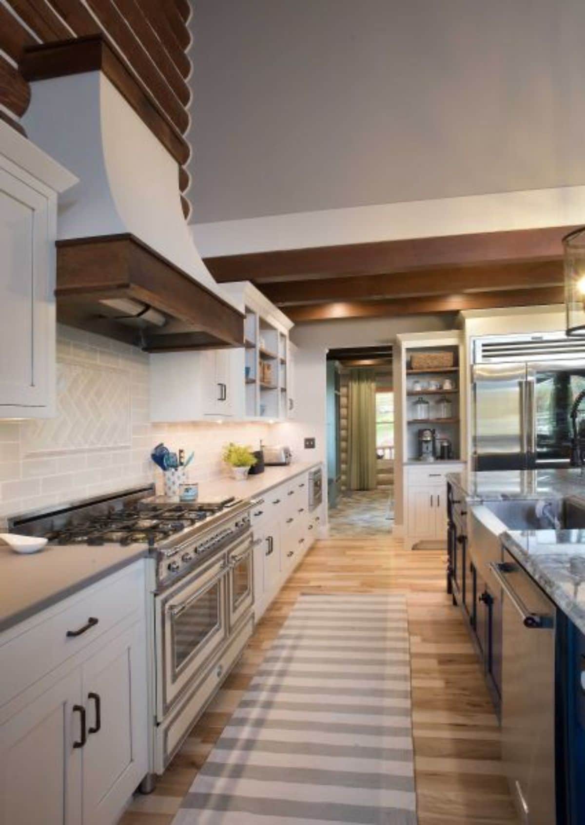 white cabinets in kitchen with gas stainless steel stove on left