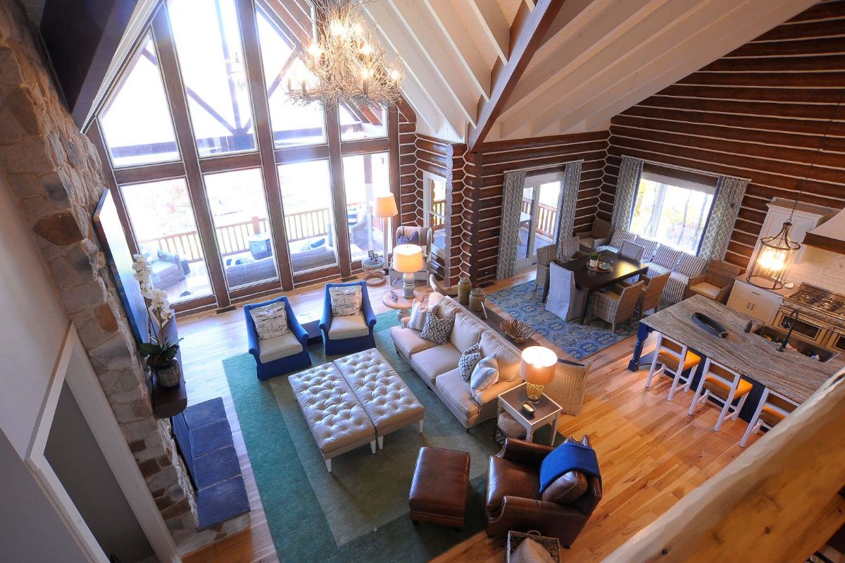 view into living room from loft with green rug under furniture