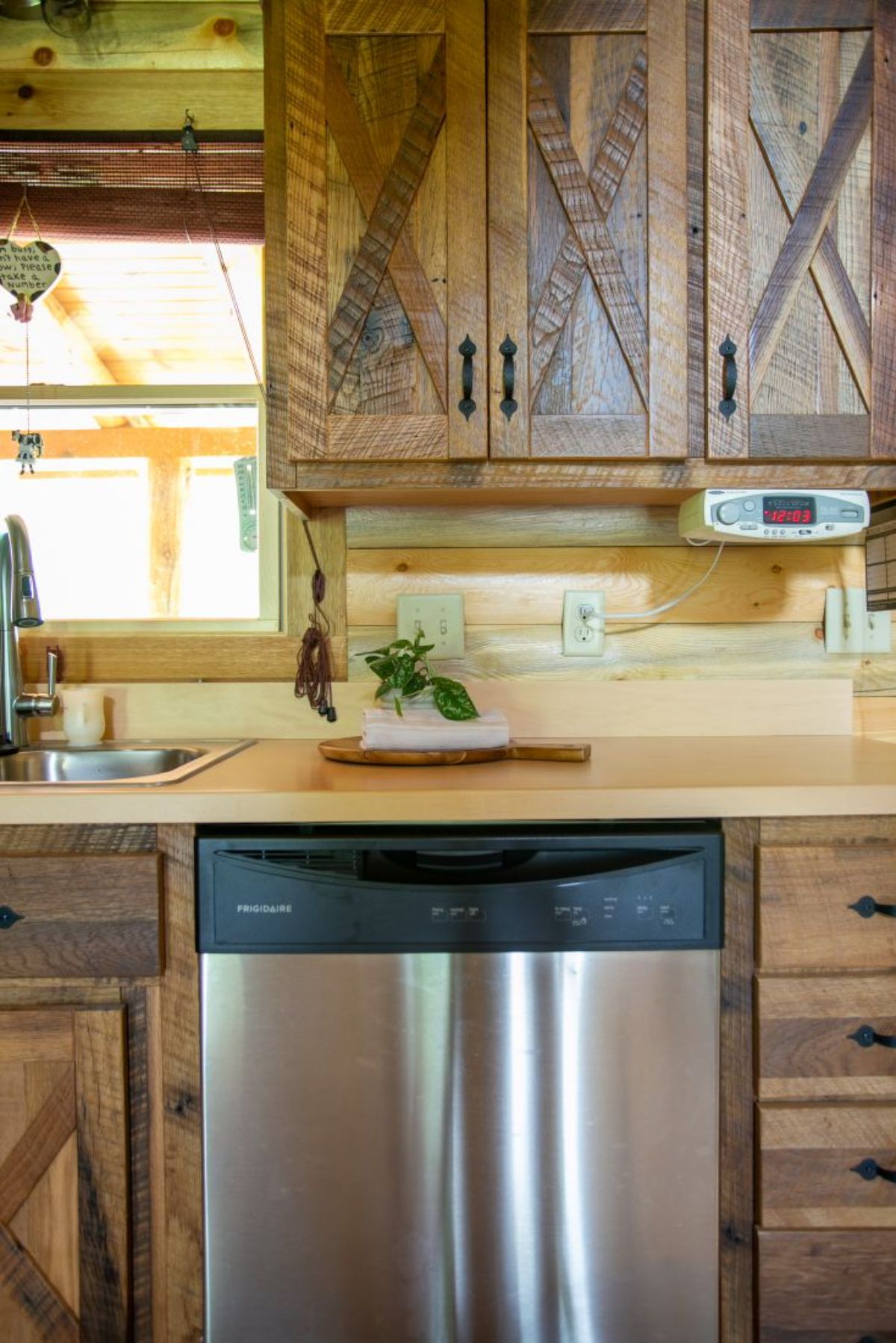 dishwasher under light cream counter with medium wood cabinets