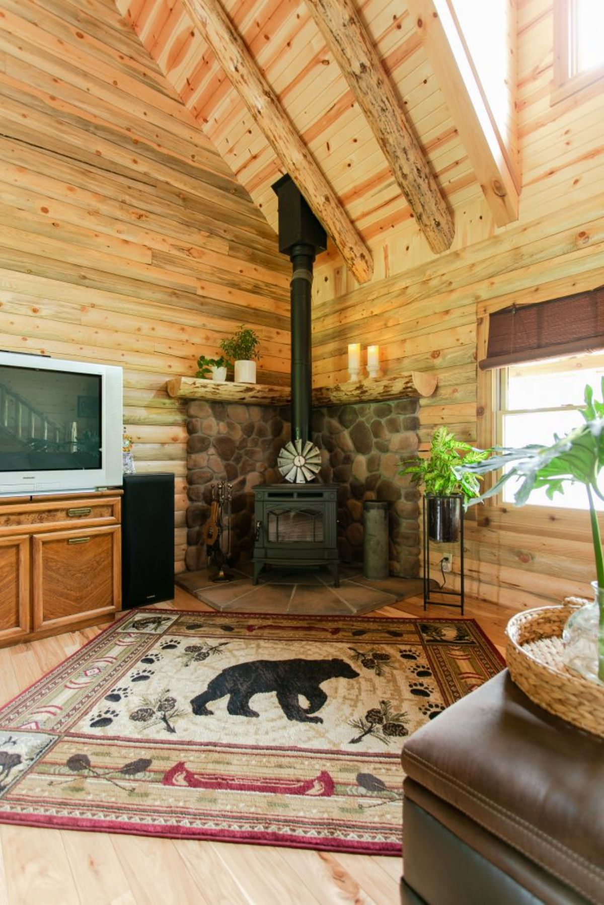 rug with bear on it in front of wood stove with stone background