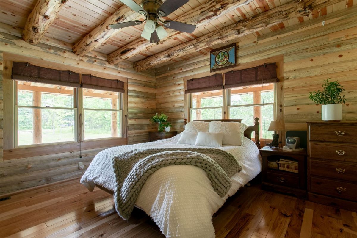 white bedding with gray throw on bed under ceiling fan