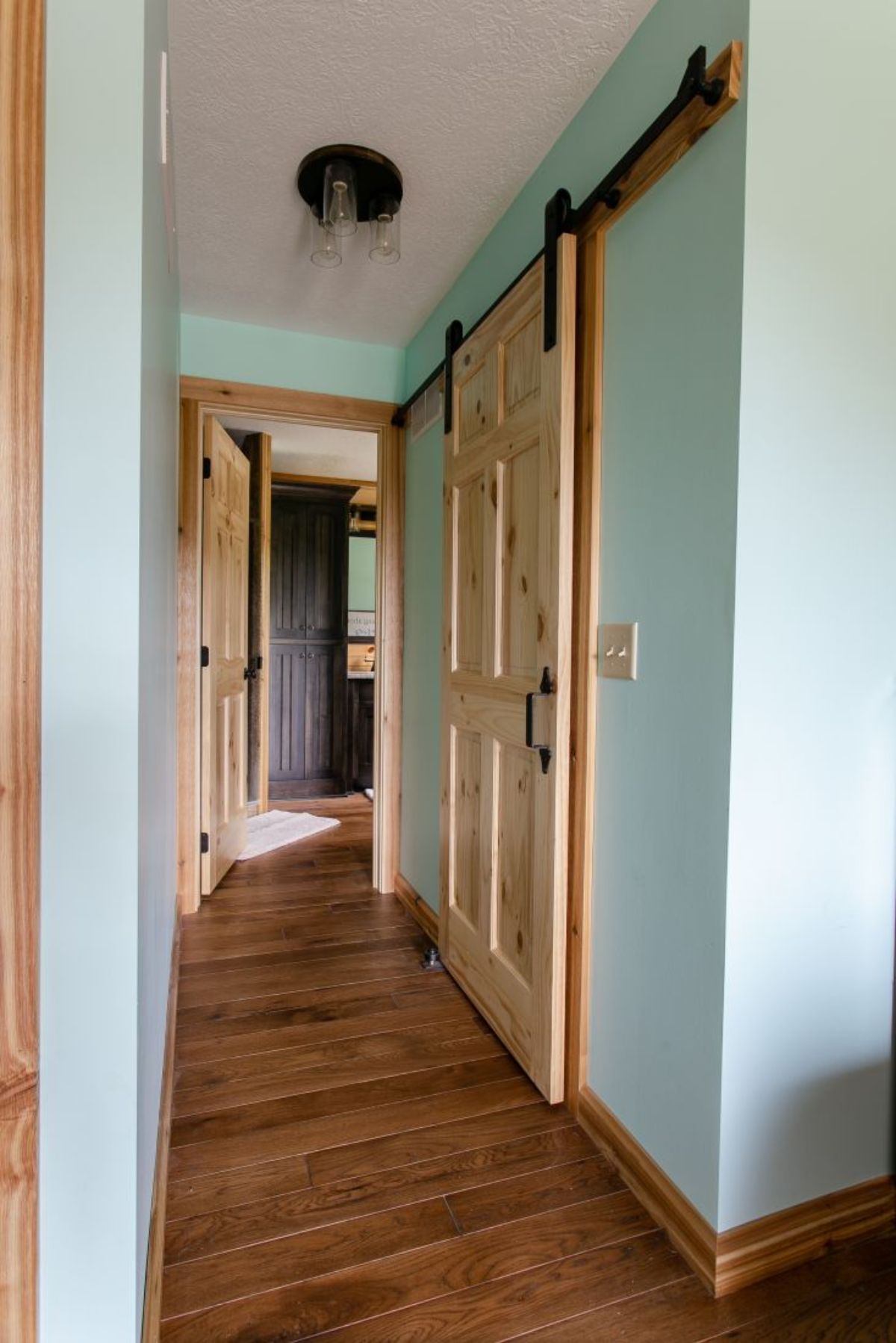 short white wall with light wood doors