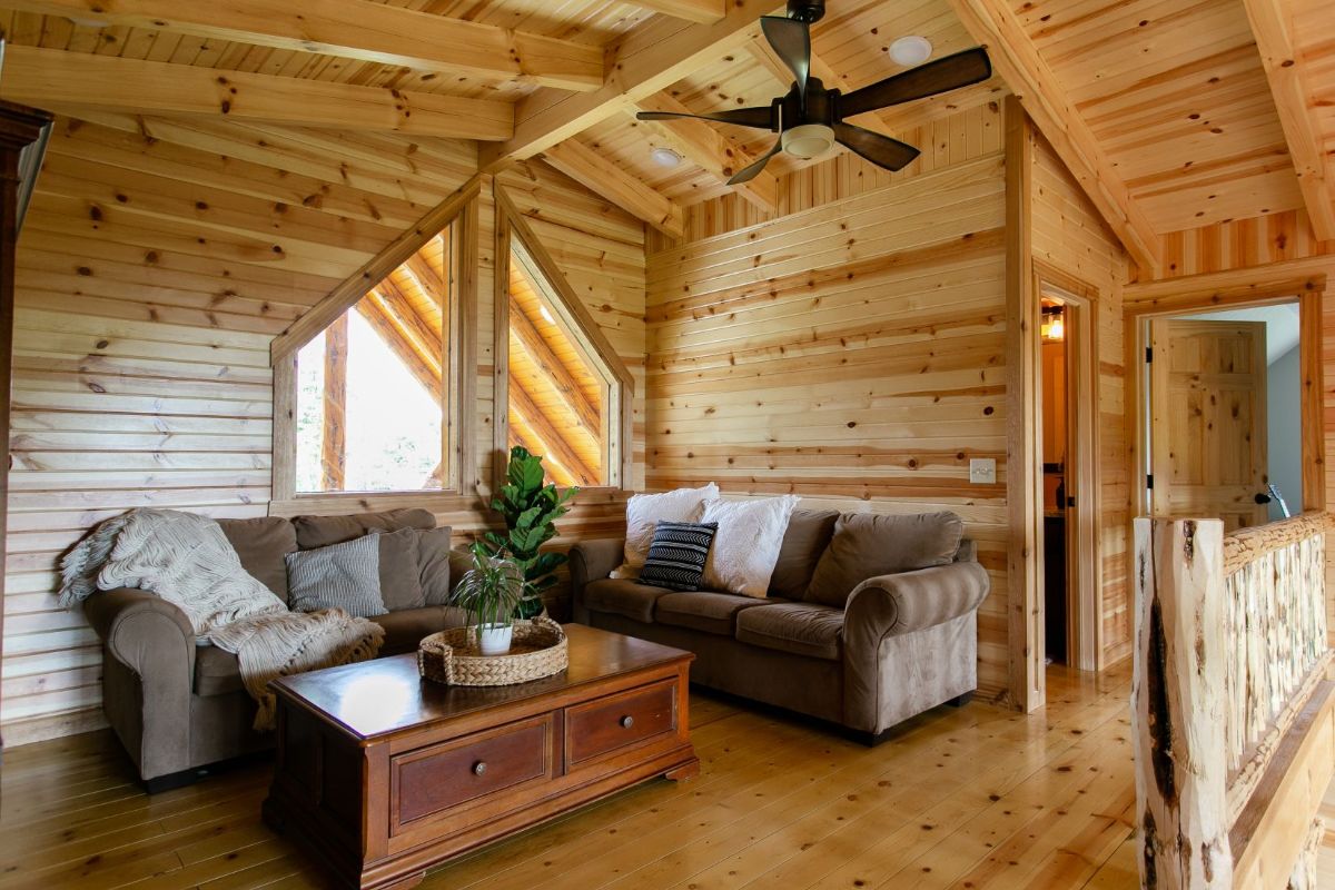 loft family room with light brown sofa against wall with wood cofee table in front