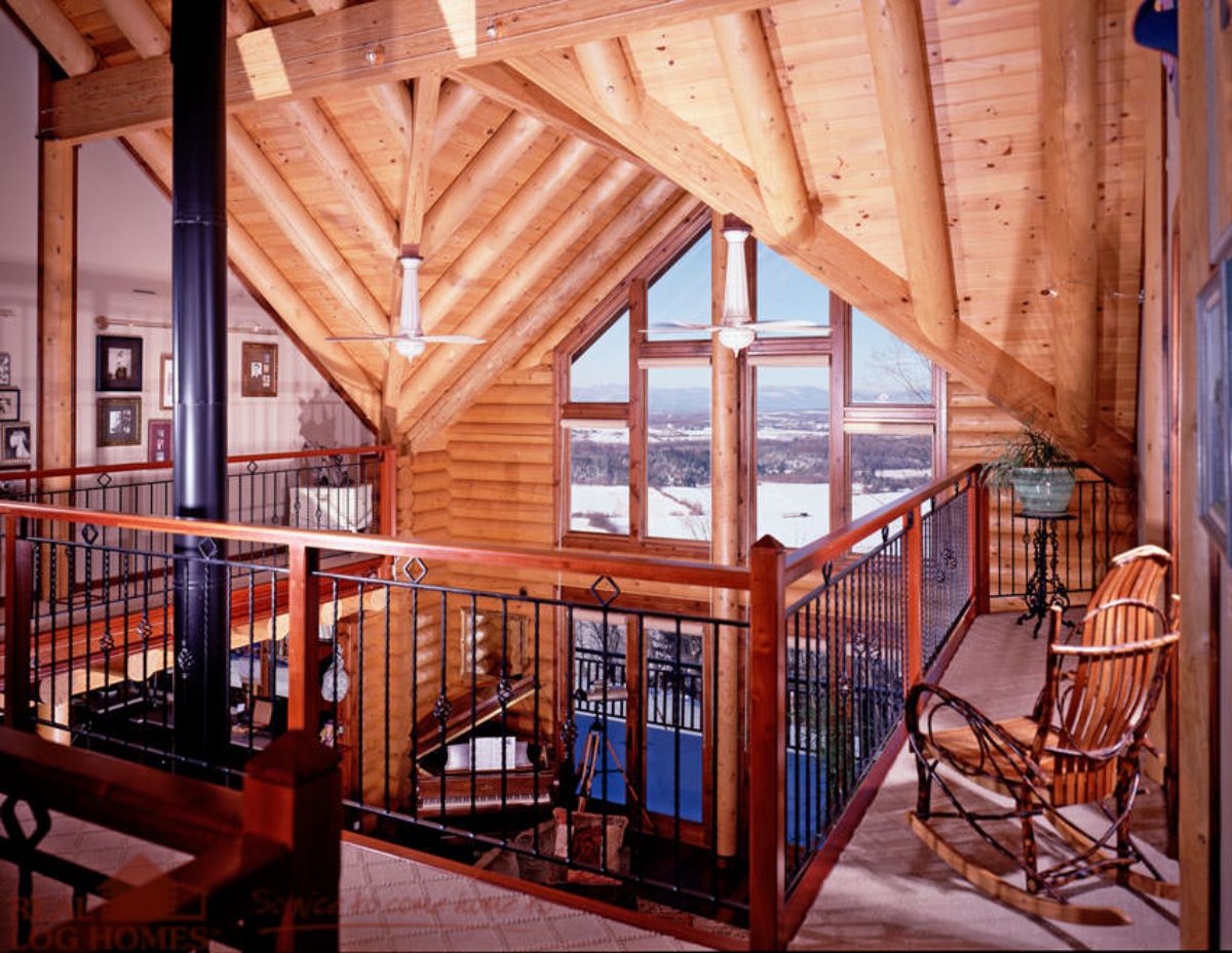 view across top of log cabin from loft landing with chimney to left