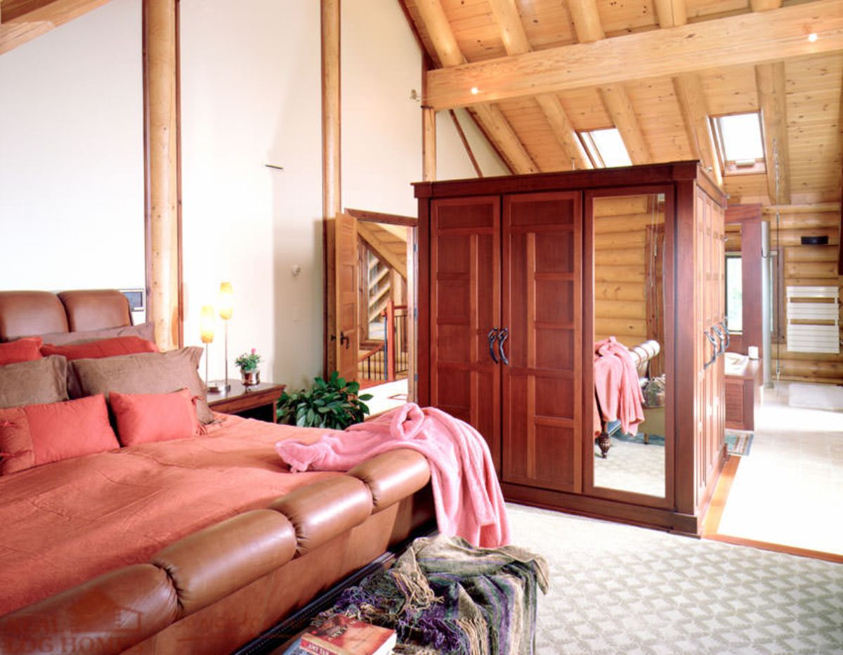 view across bedroom to open wardrobe in center