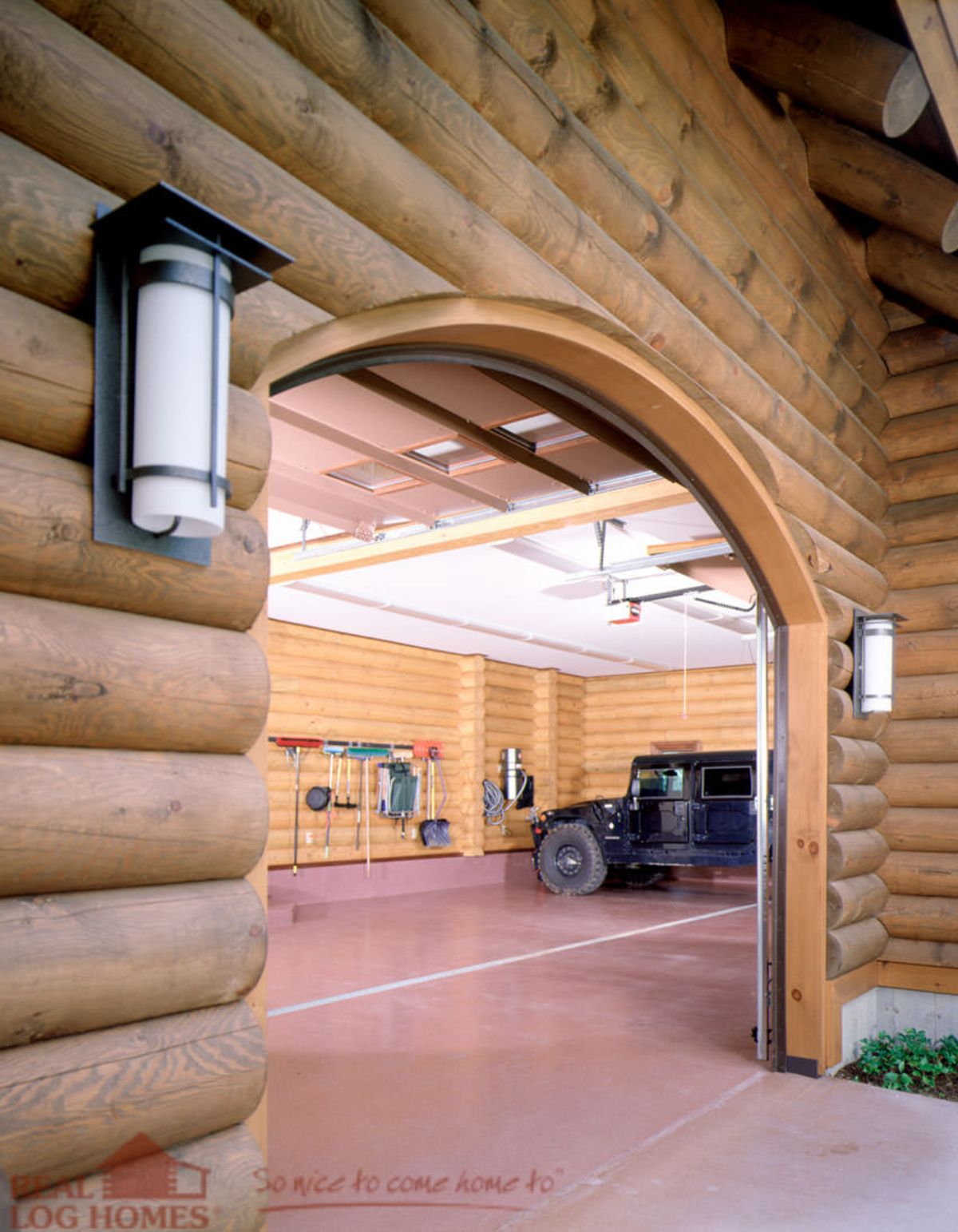 arched open garage door with black jeep inside