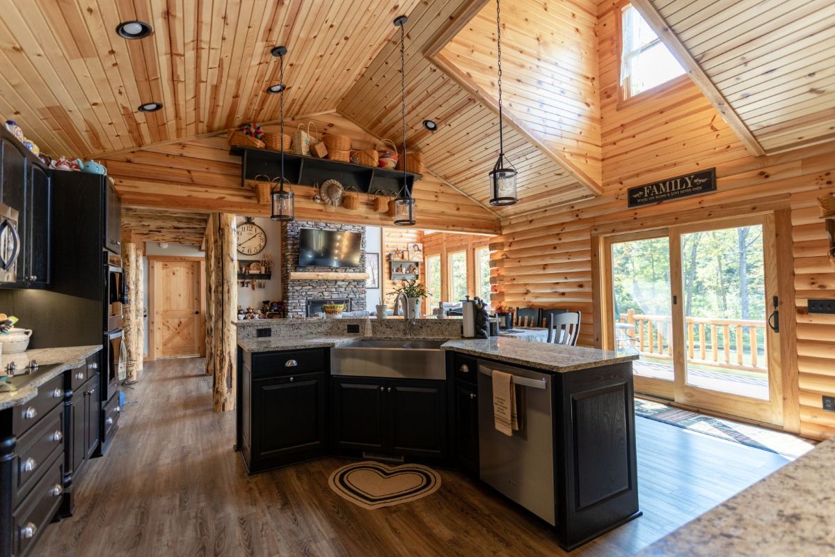 kitchen with dark wood cabinets and island in middle of space with sunlight above