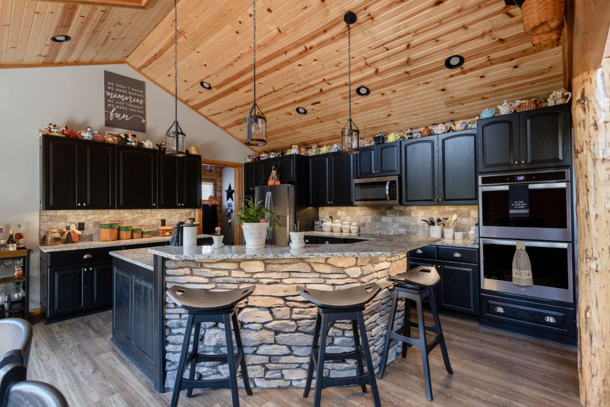 stone veneer on outside edge of kitchen bar with stools