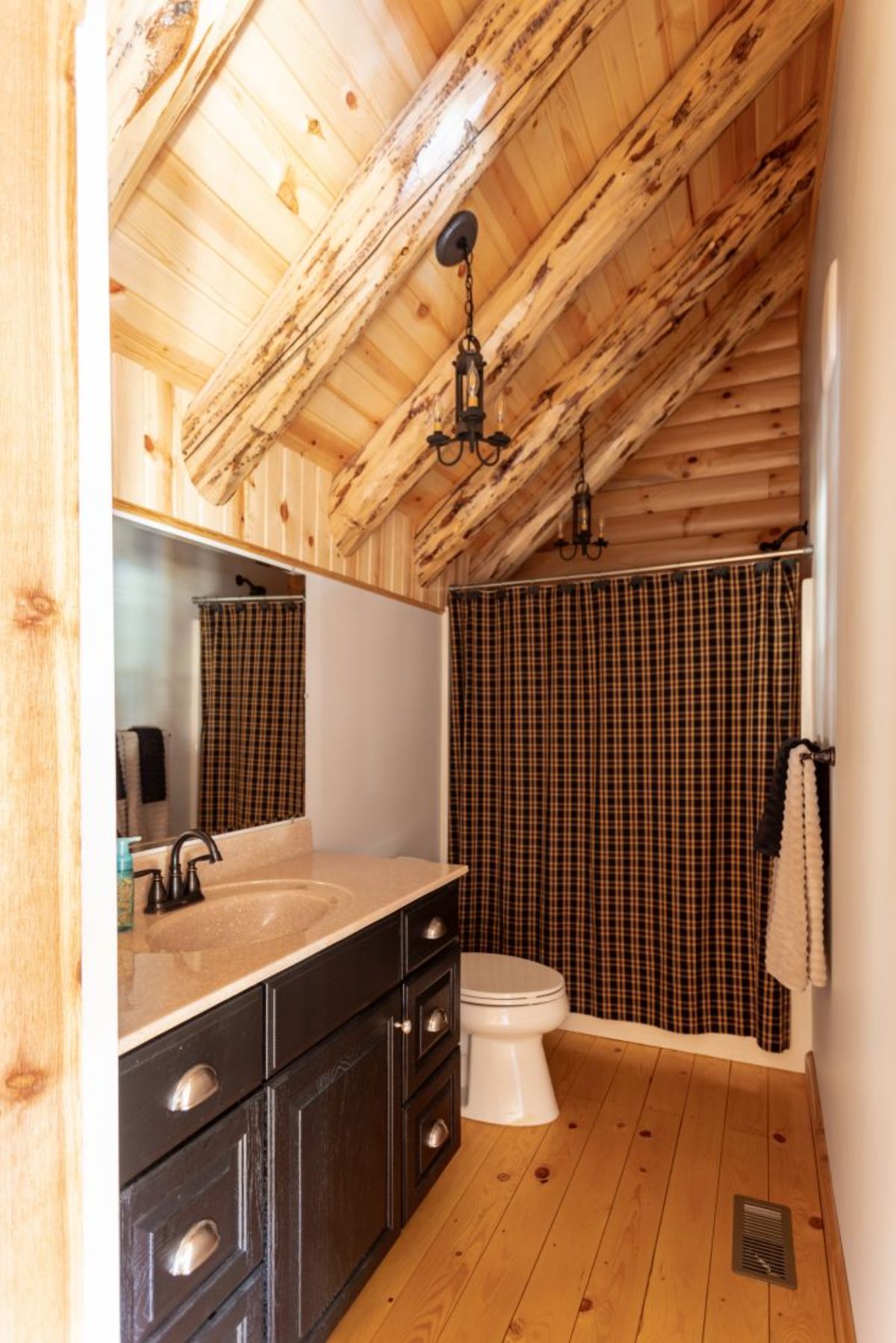 bathroom with vanity on left, white toilet, and combination bathtub and shower