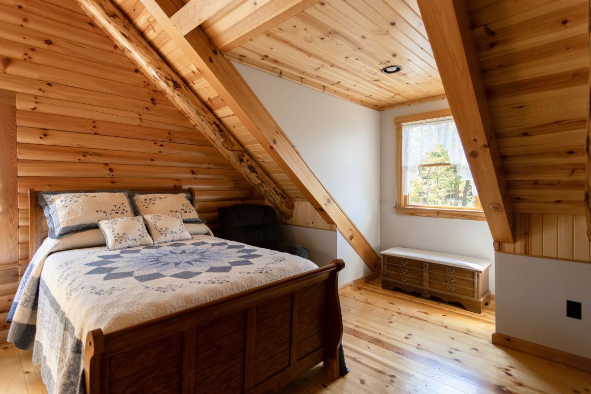 bed in loft room under dormer window