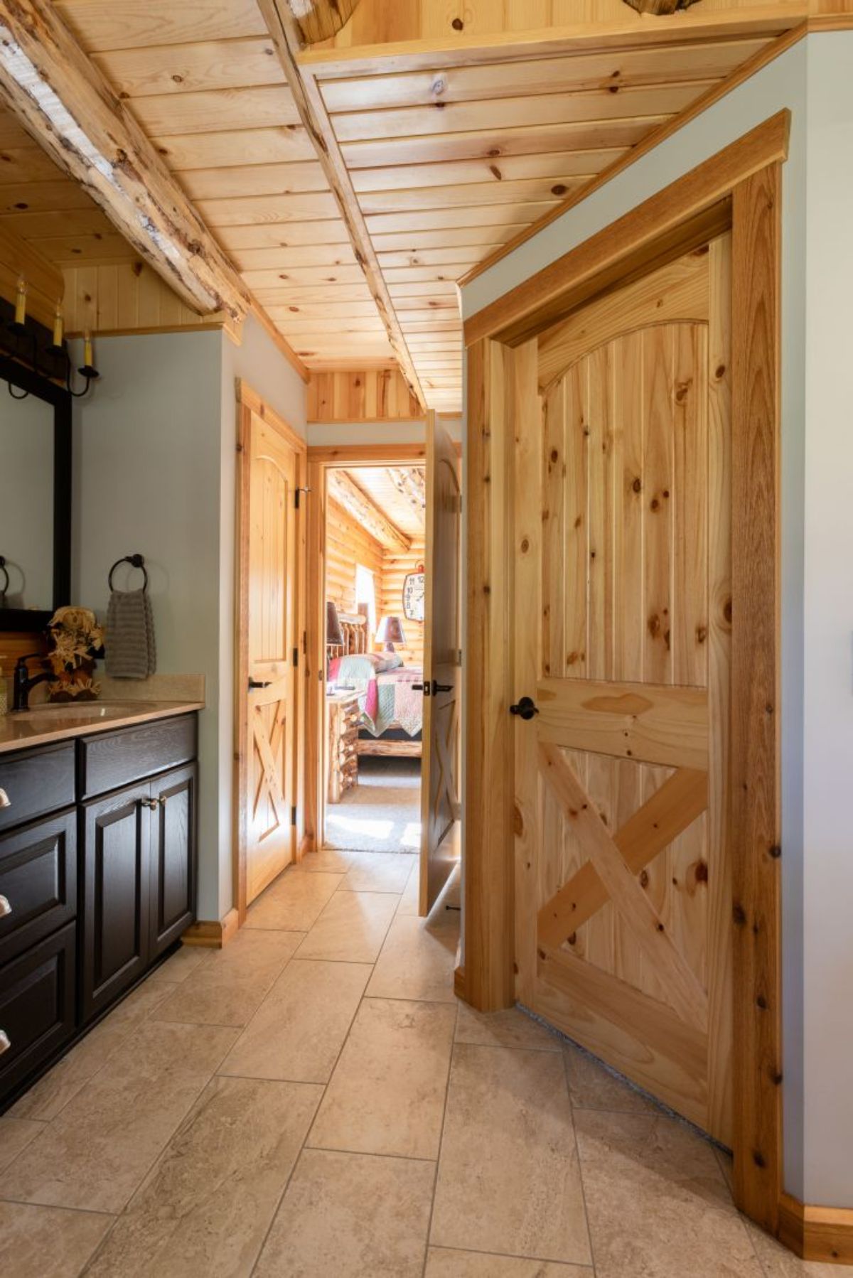 open door into bathroom with dark vanity on left