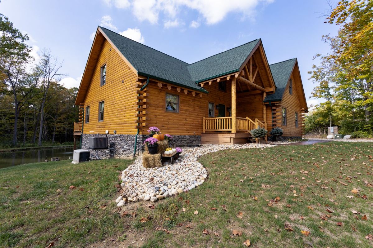 rock landscaping around front porch and side of log cabin