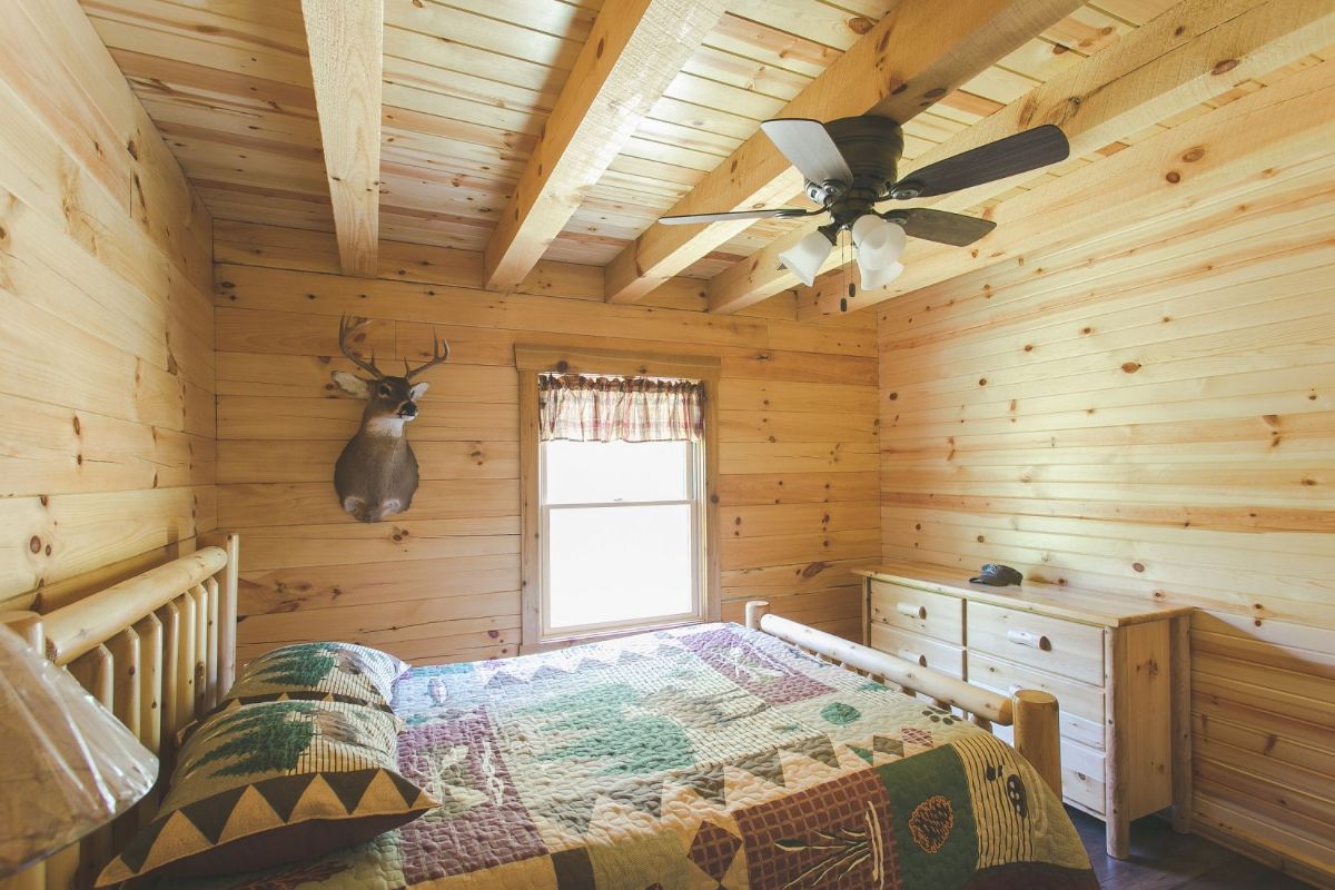 country themed bedding on bed in cabin