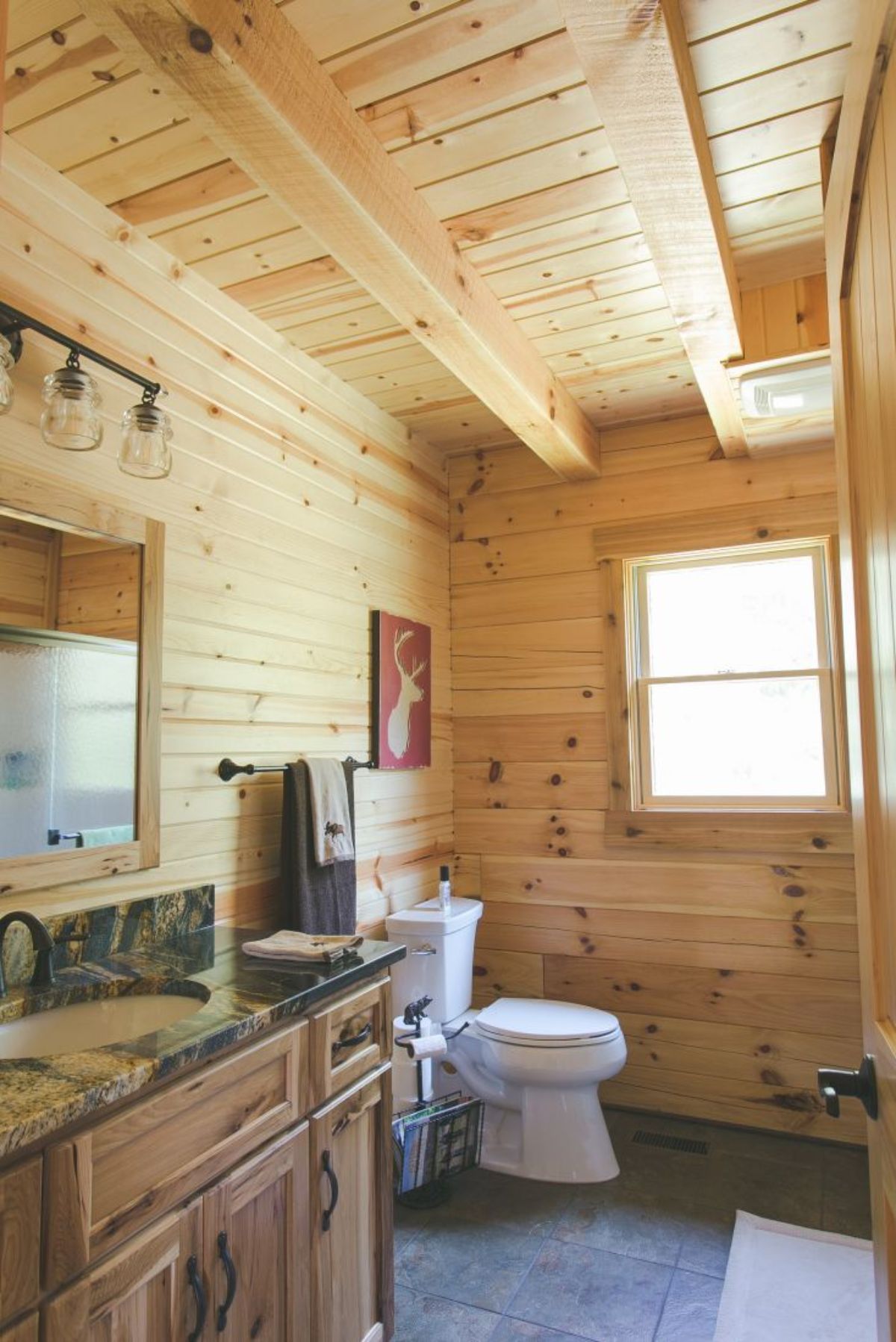light wood walls in bathroom with vanity to left