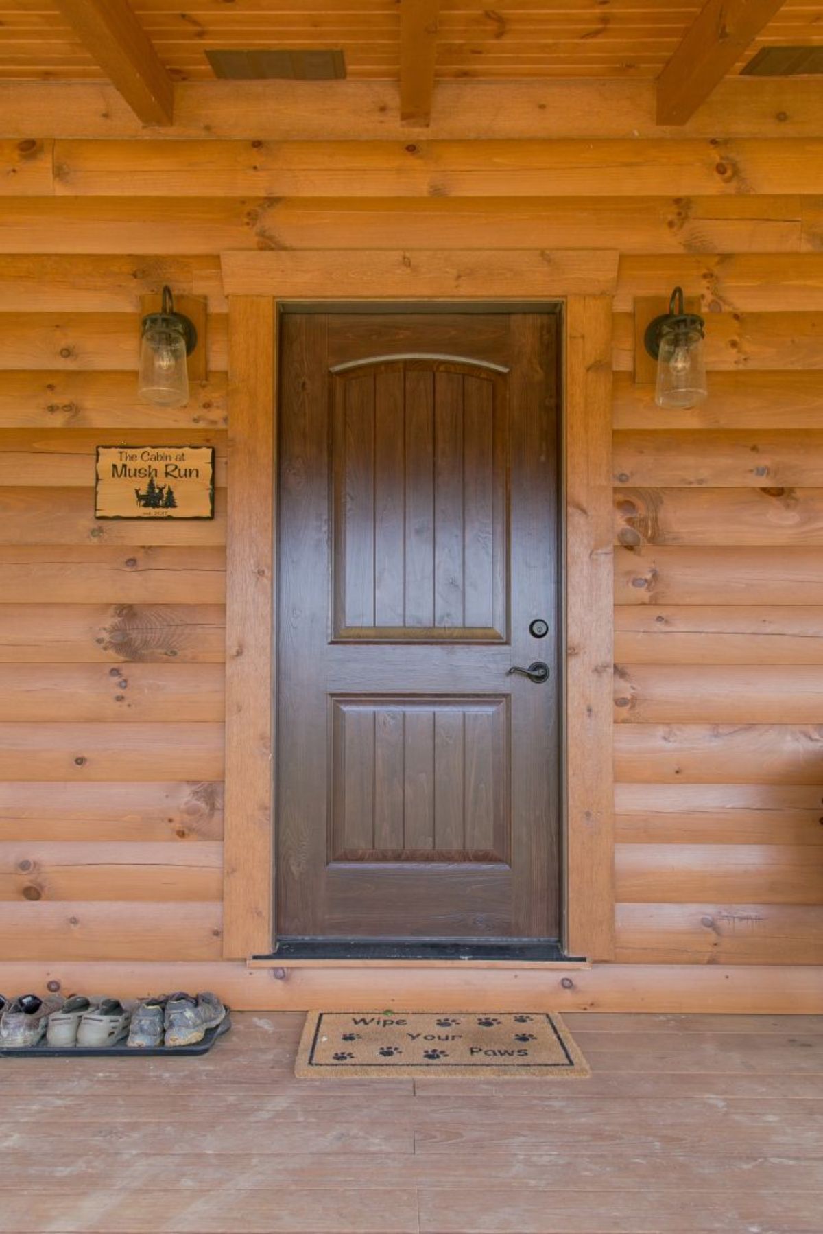 brown wood door on log cabin porch