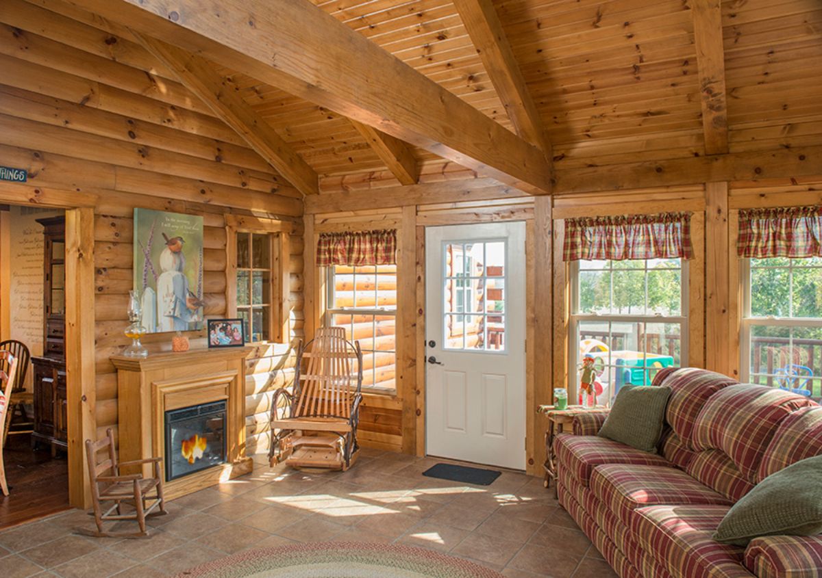 white door with windows on both sides and brown sofa on right