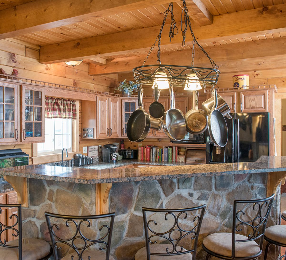 stone veneer on island bar with wire backed stools