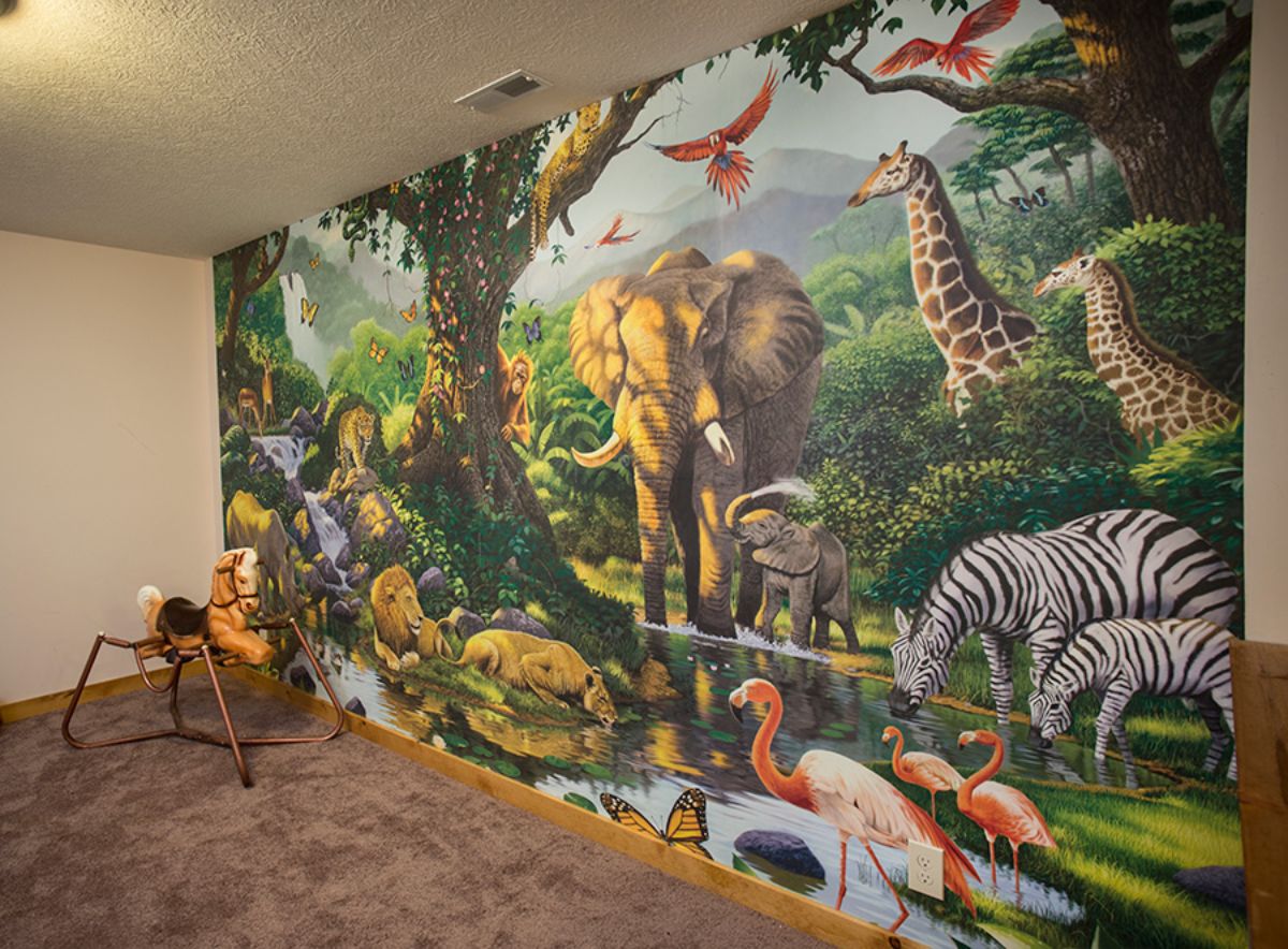 wildlife mural on wall with elephant and giraffe