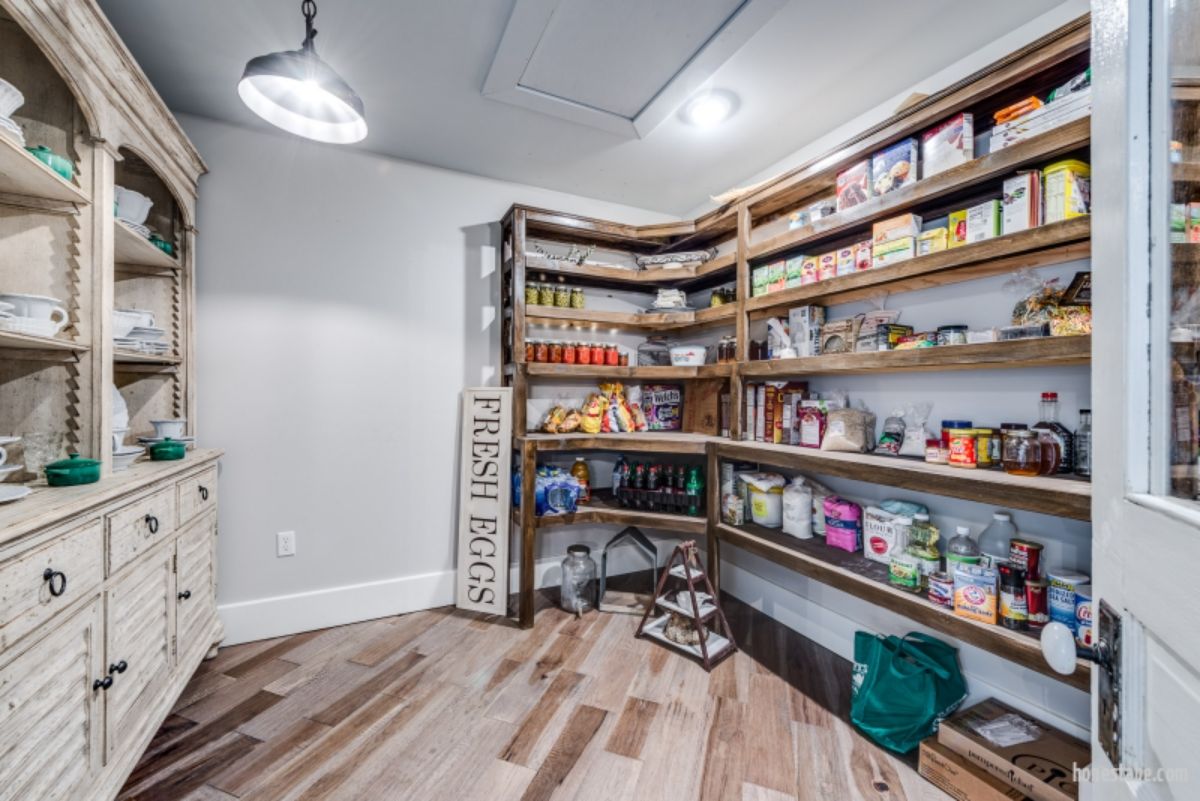 shelves against wall in pantry filled with food