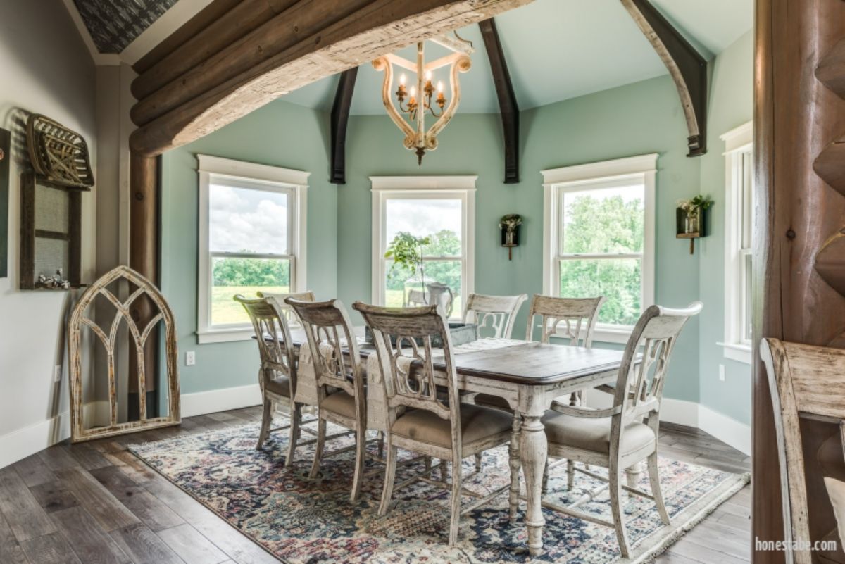 light green paint in dining room with white washed wood dining table