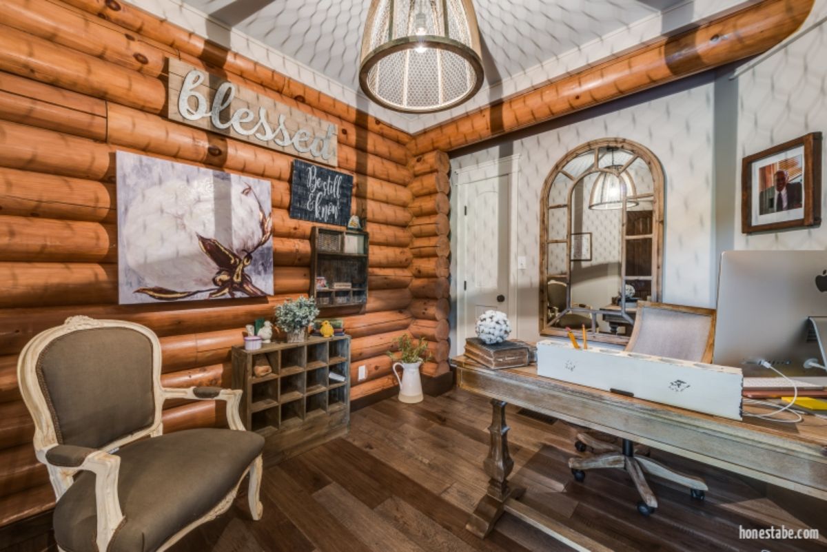 log walls in living room of cabin with round light fixutre