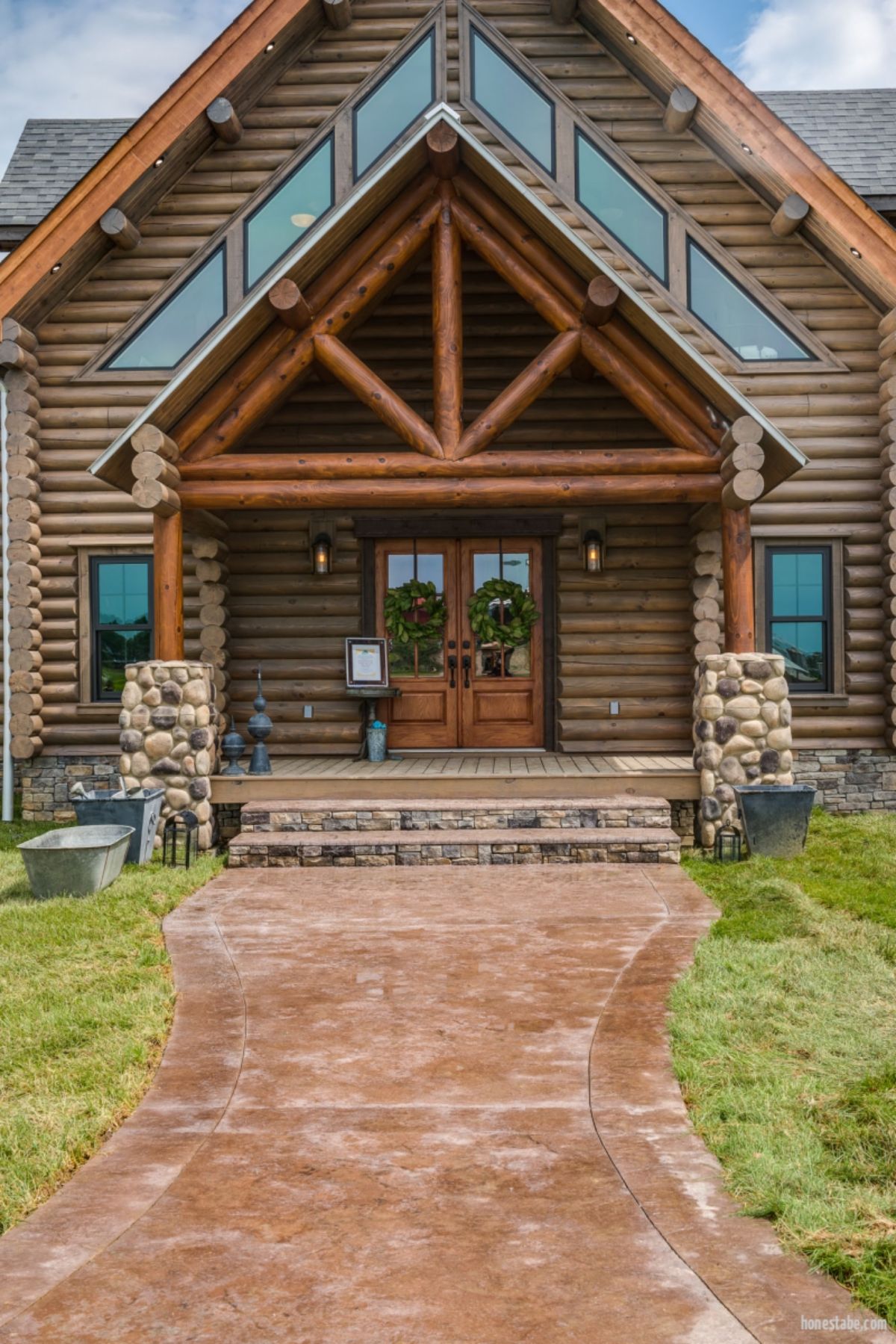 front door with covered porch on front of log cabin