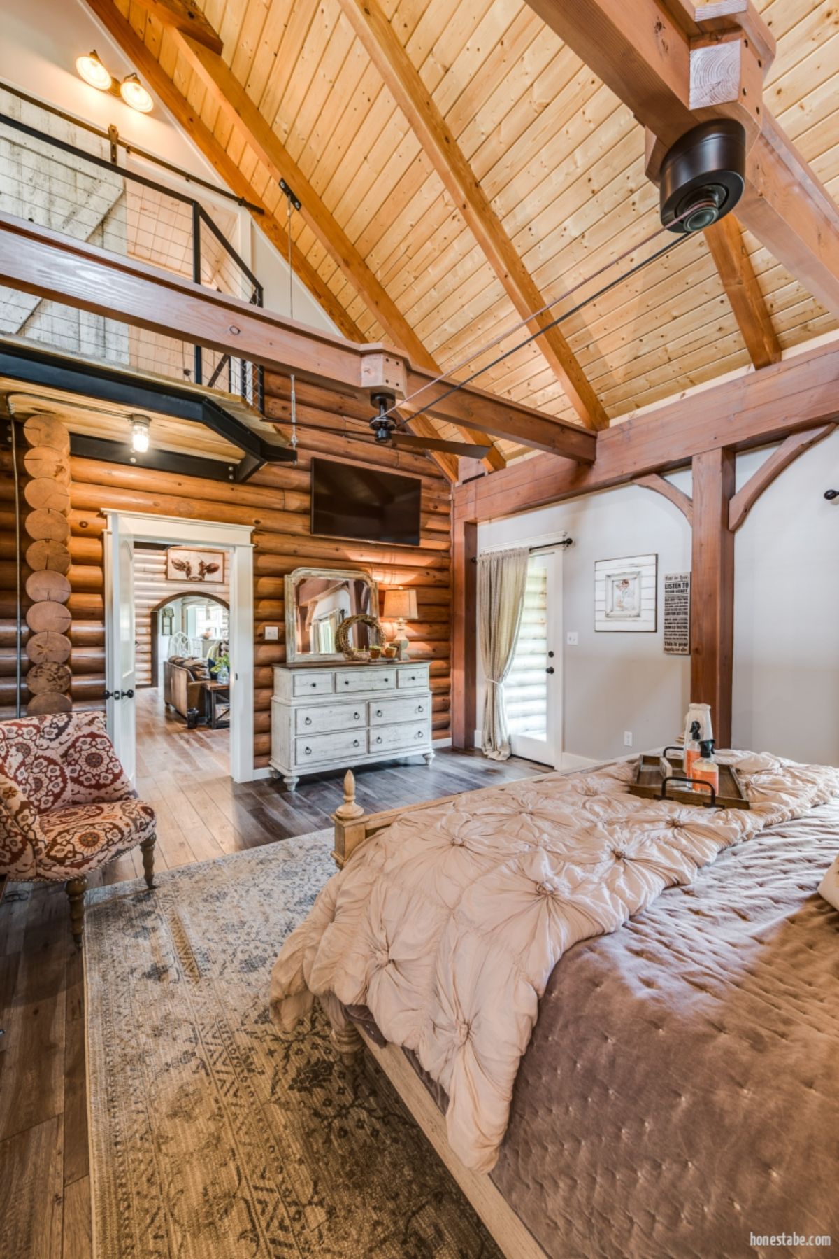 view across bedroom to open door showing archway to second room