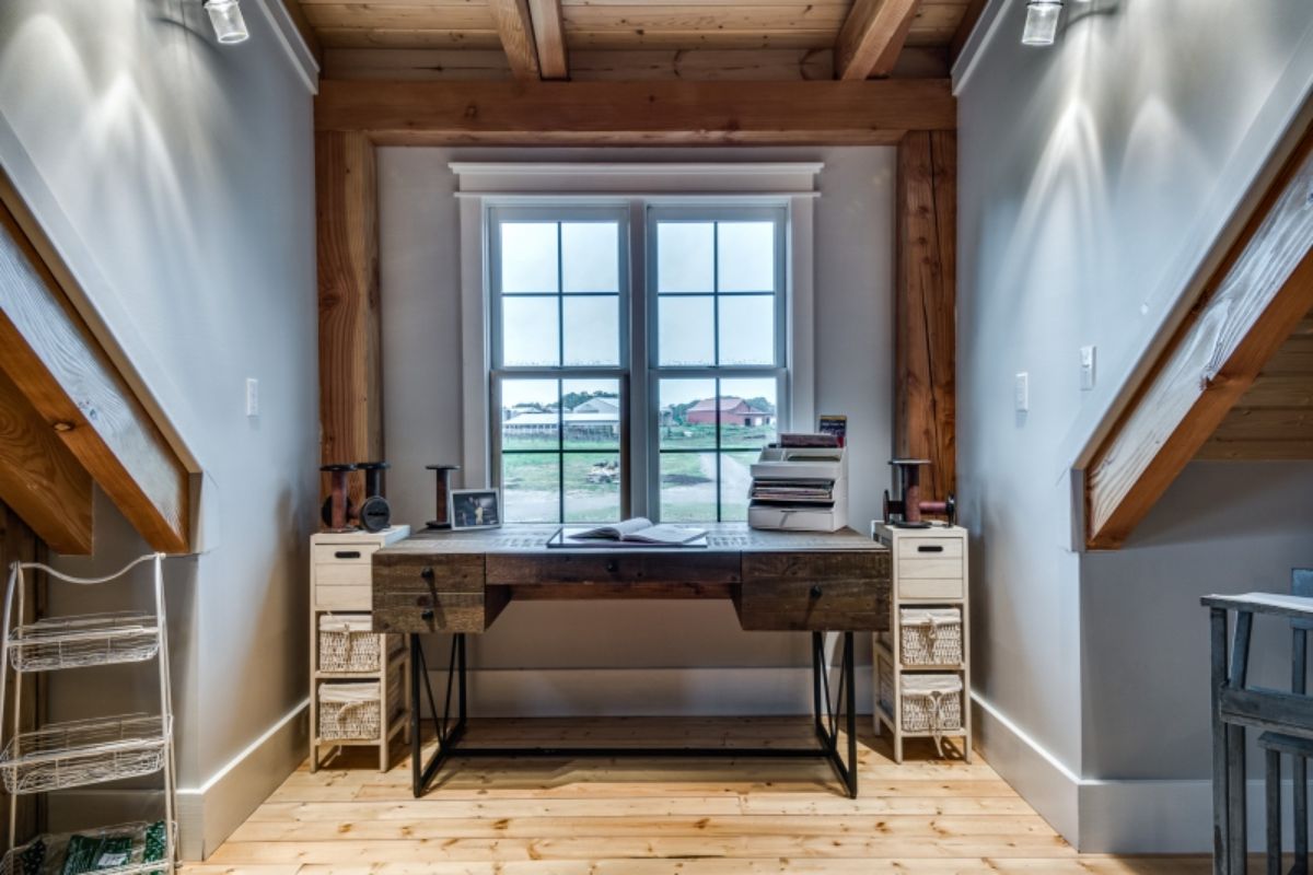 gray wood desk with white carts on both sides underneath window