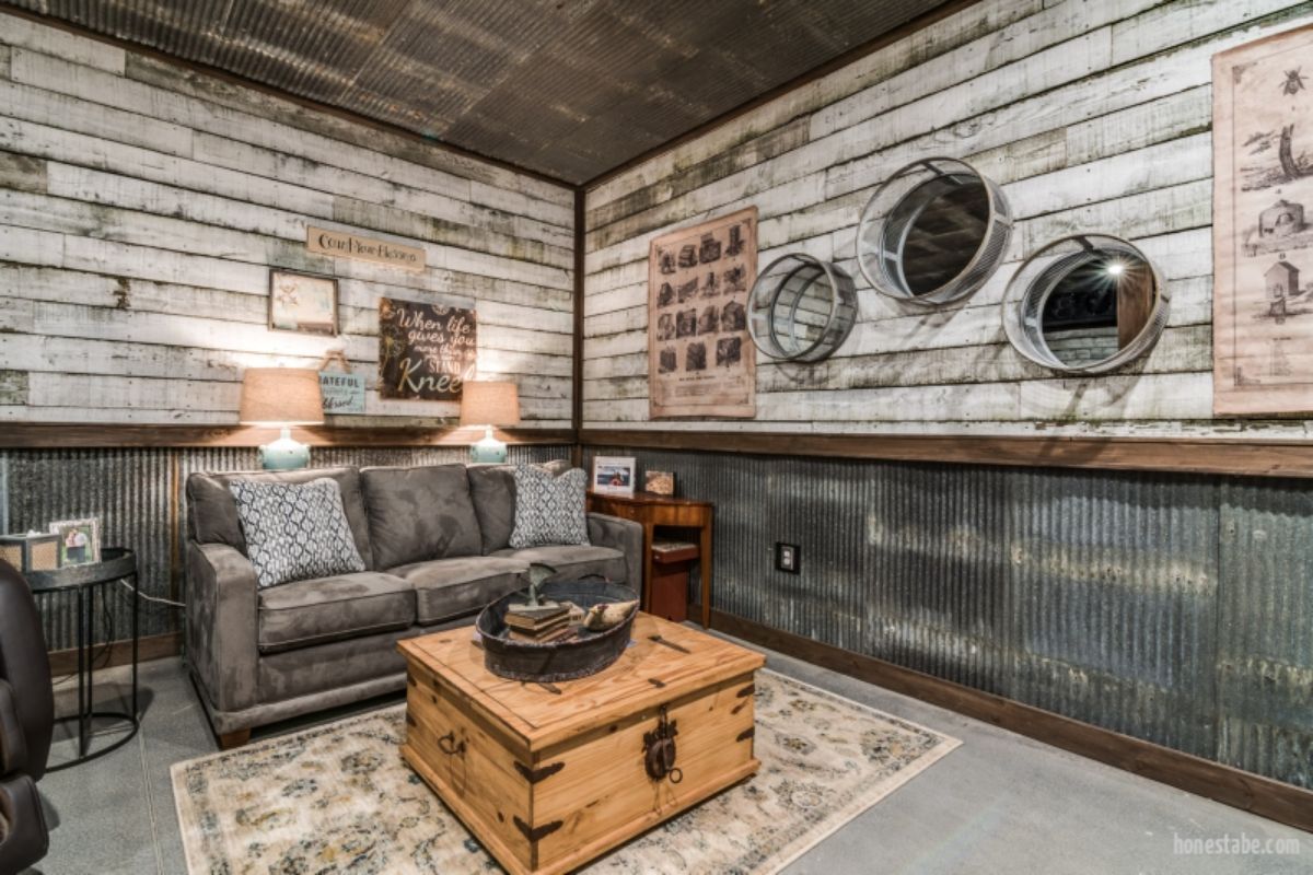 gray sofa against wall with light wood walls