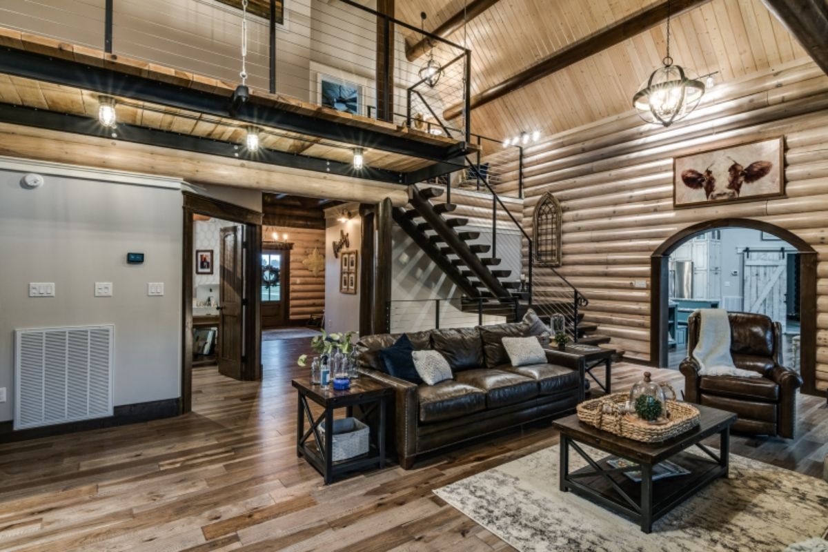 gray sofa underneath loft landing in log cabin living room