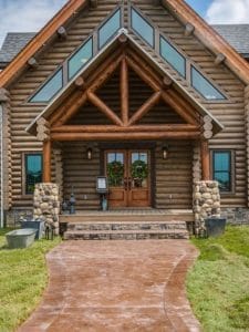 front door to log cabin with beautiful angled windows