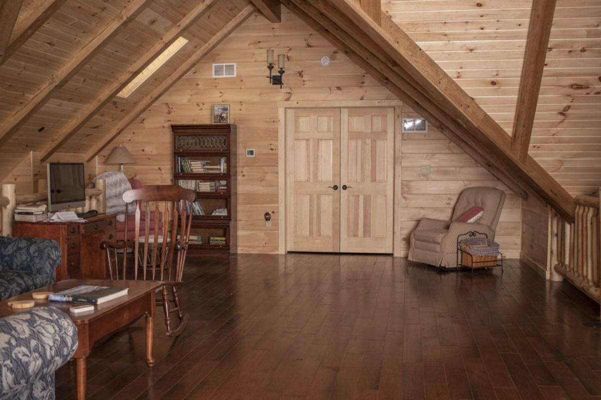 open loft in log cabin with table on left