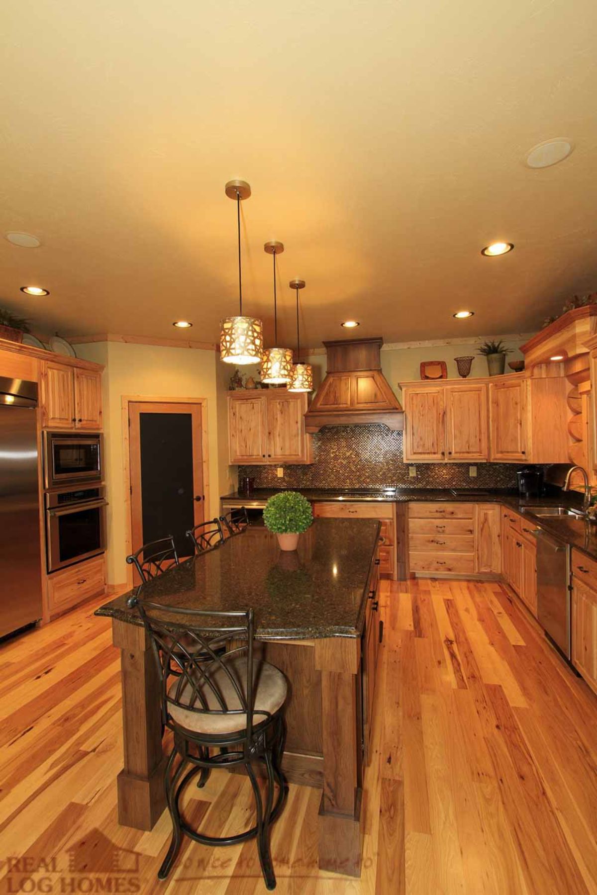 log cabin kitchen with stainless steel appliances and center island