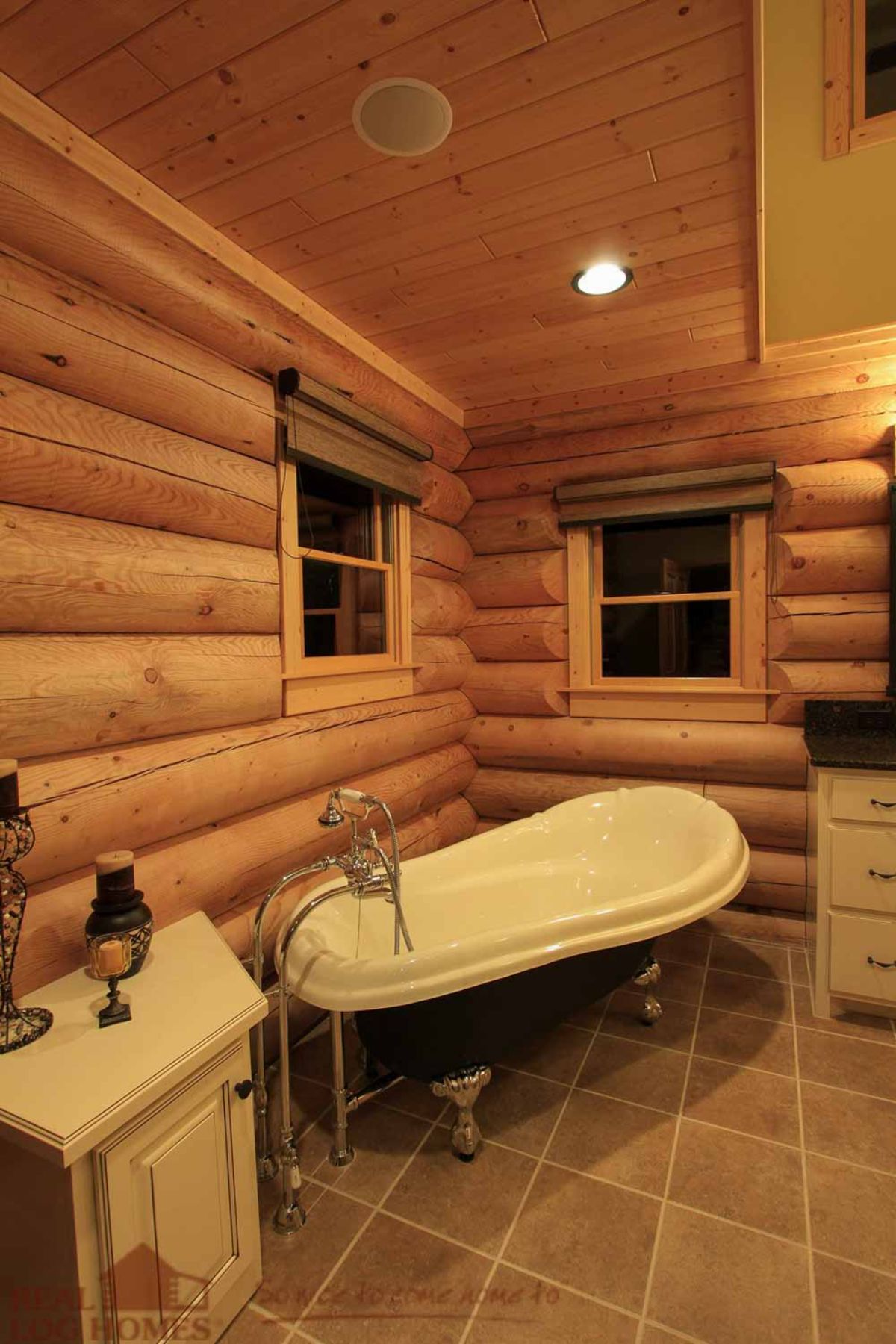 white soaking tub in log cabin bathroom