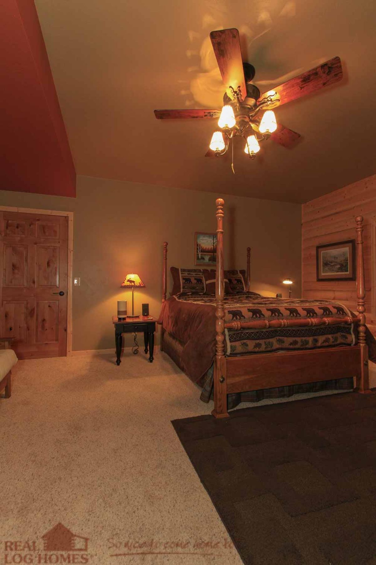 canopy bed against wall of log cabin bedroom