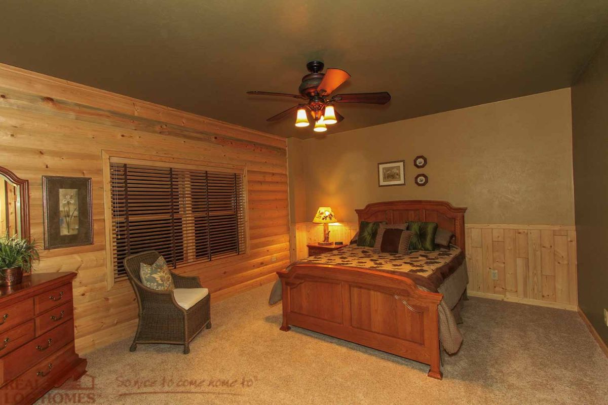 bedroom with light green ceiling and wood bedframe