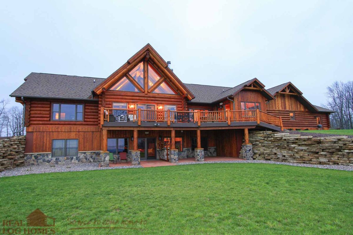 log cabin back deck overlooking property with walkout basement and wall of windows