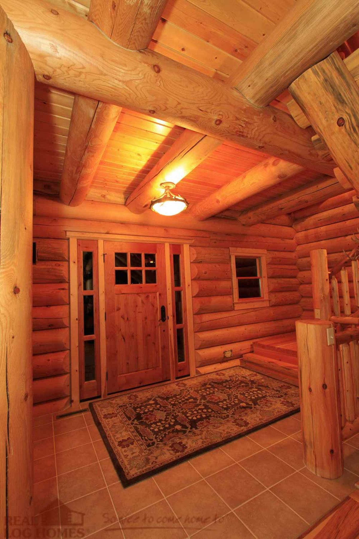 inside of front door to log cabin with rug