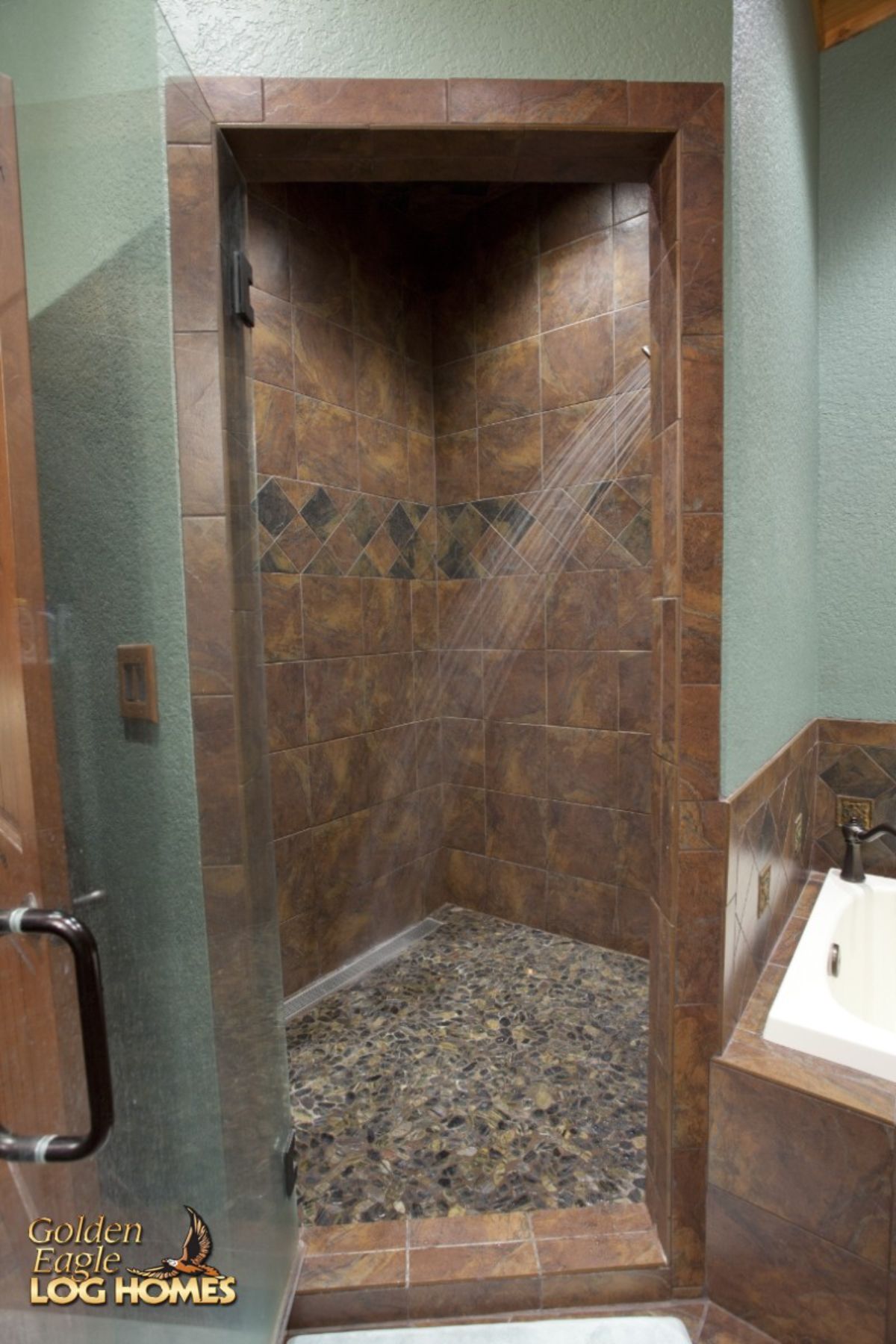 tiled corner shower with light green wall on the outside