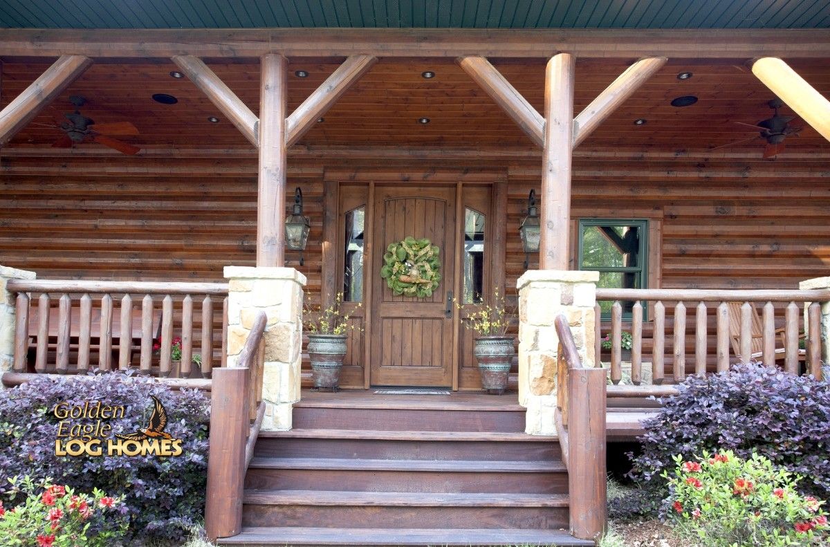 light wood door with greenery wreath on porch