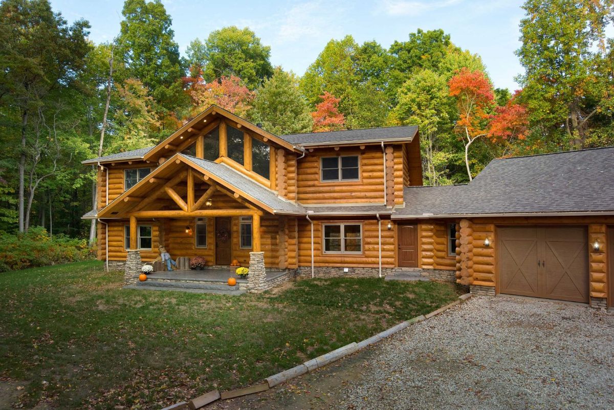 medium wood stain on two story log cabin with covered front porch