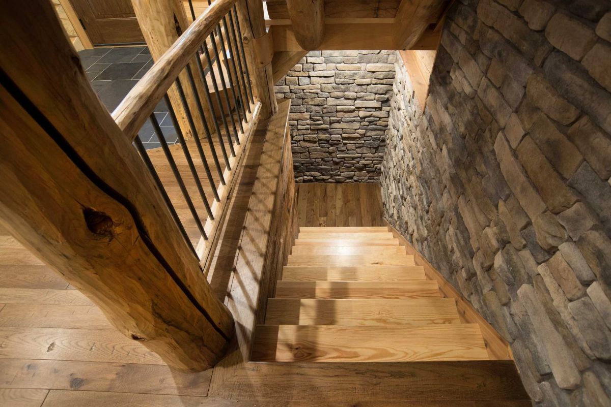 view down stairs with stone walls on two sides