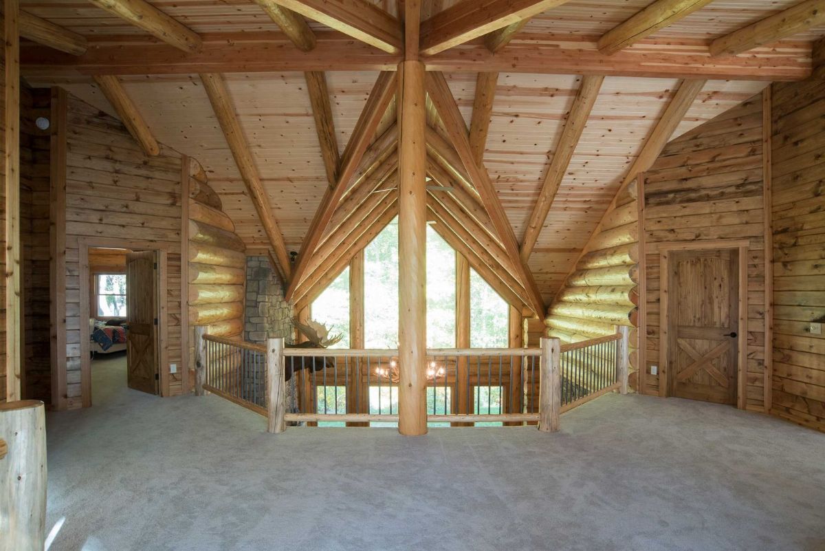 view across loft to ceiling of main living space in log cabin