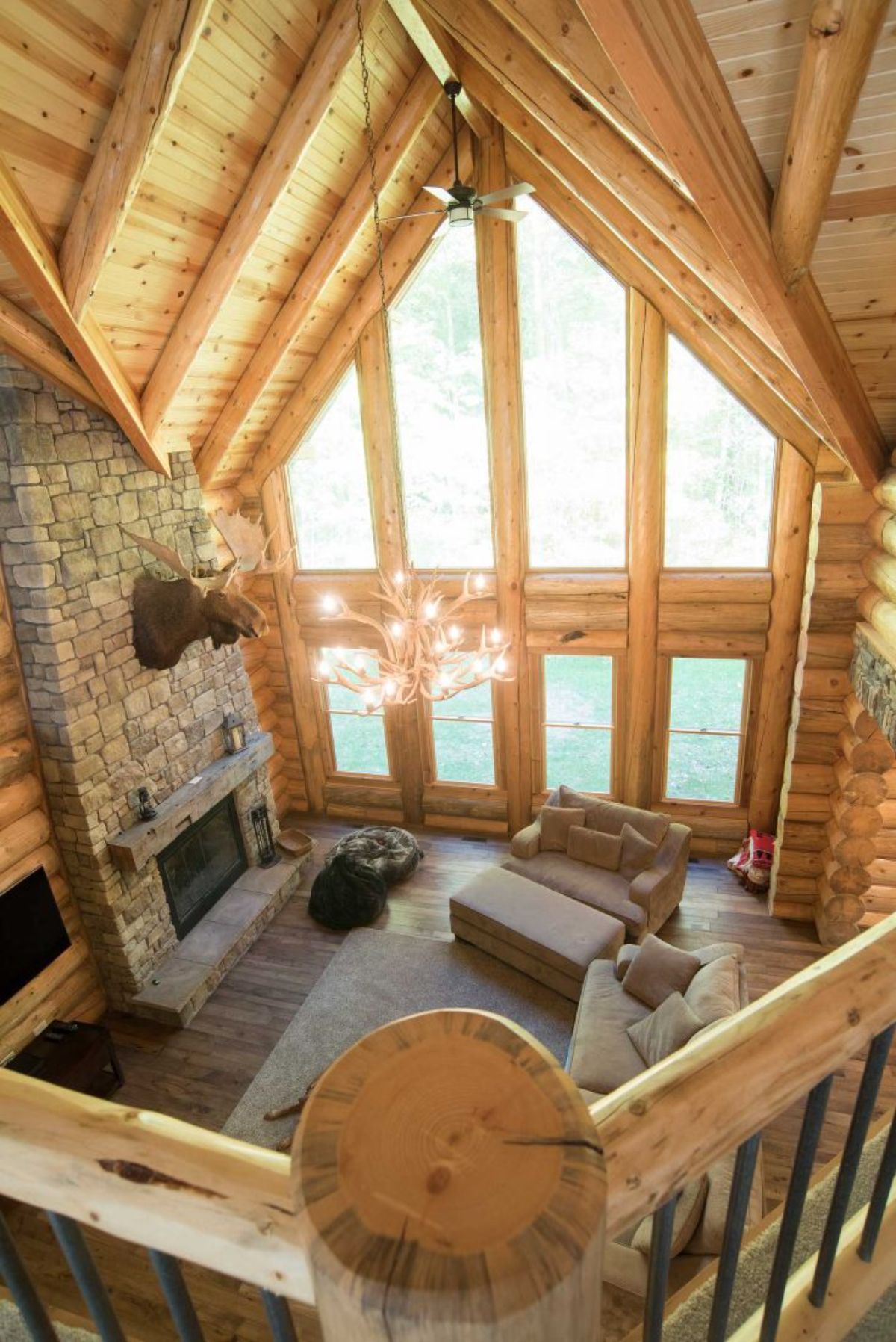 view from loft into main floor living space of log cabin