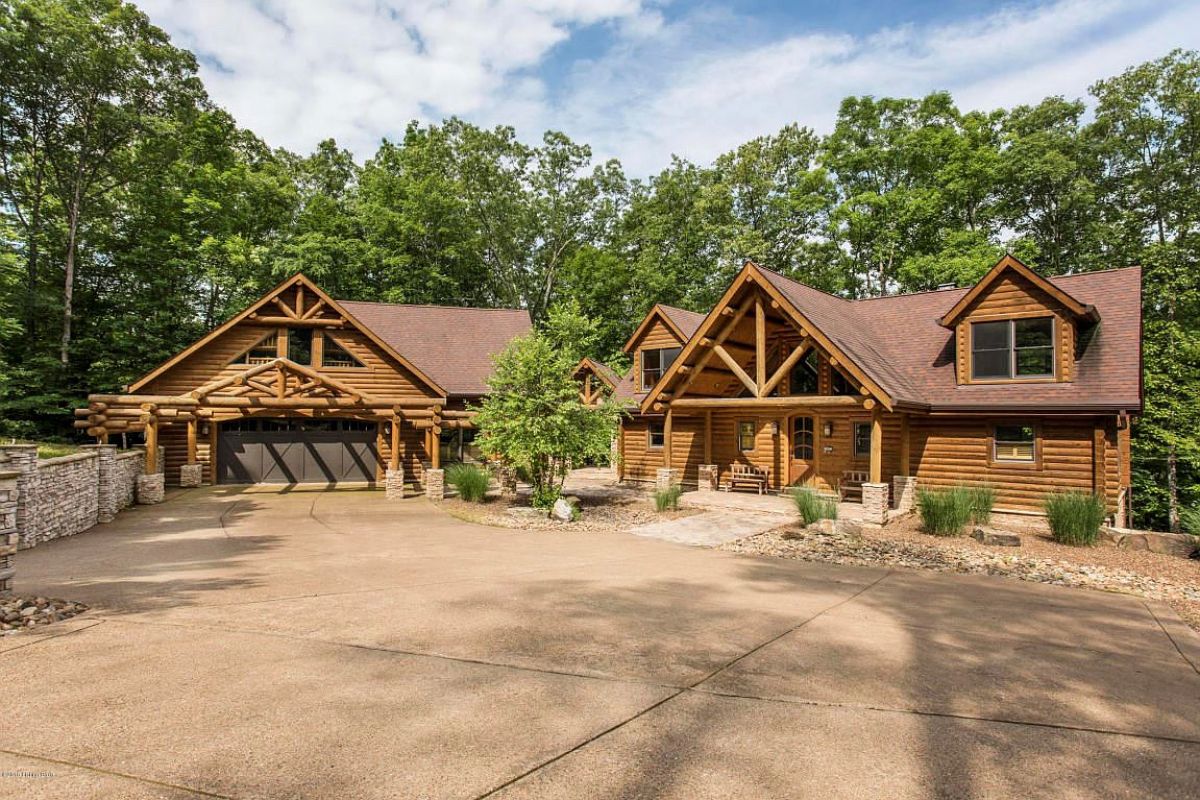 log cabin with brown garage door on left