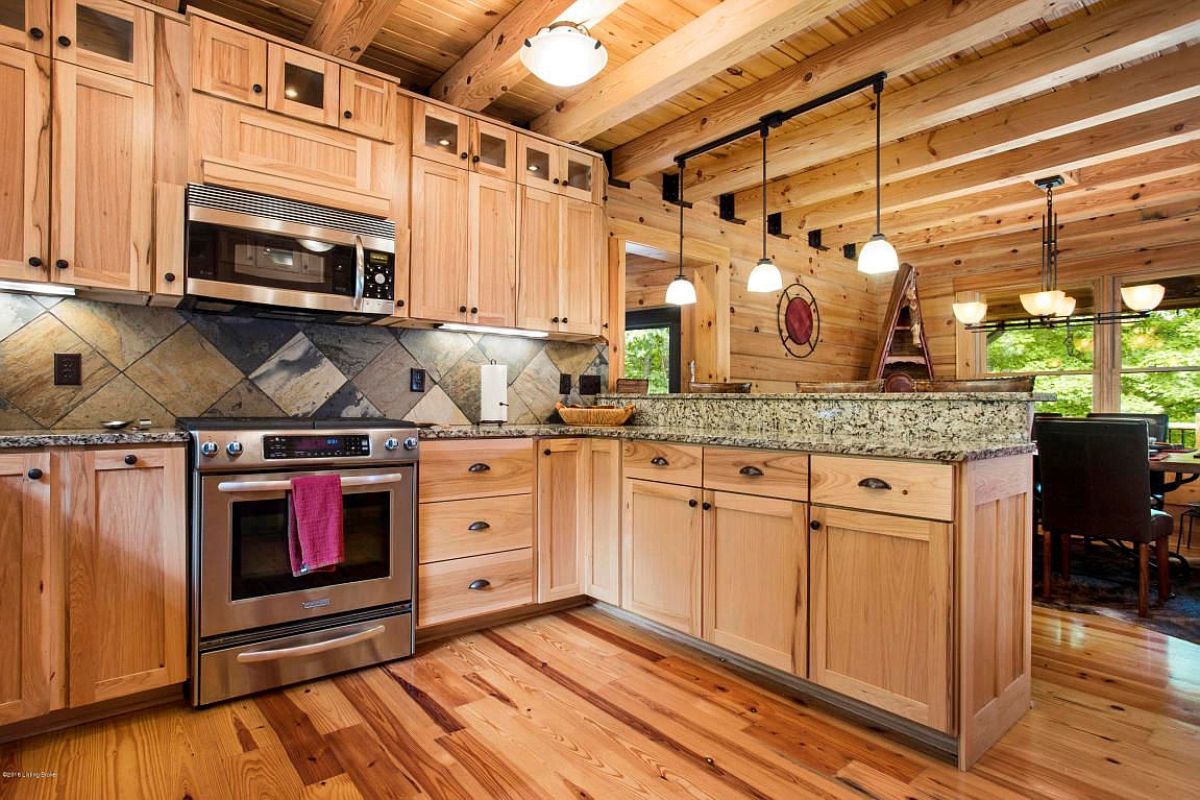 log cabin wood cabinets with stainless steel appliances and granite countertops in kitchen