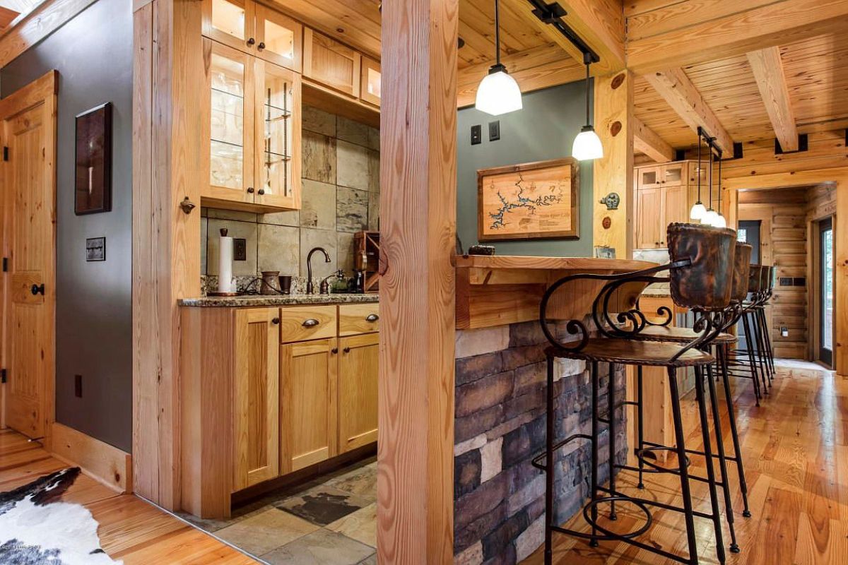 small corner bar with stone veneer wall by stools