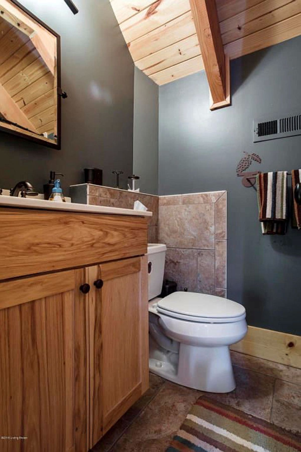 light blue wall in bathroom with cream tile