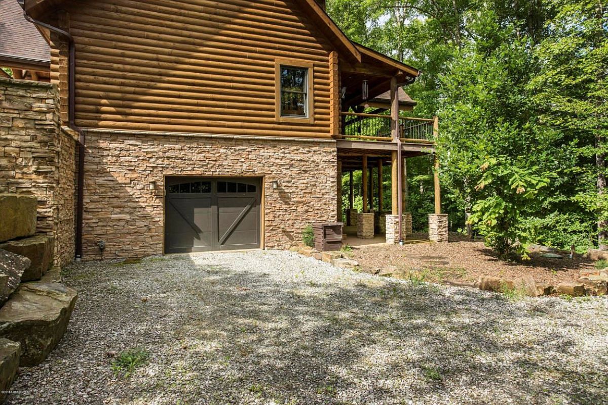 dark wood door on foundation of house with stone base