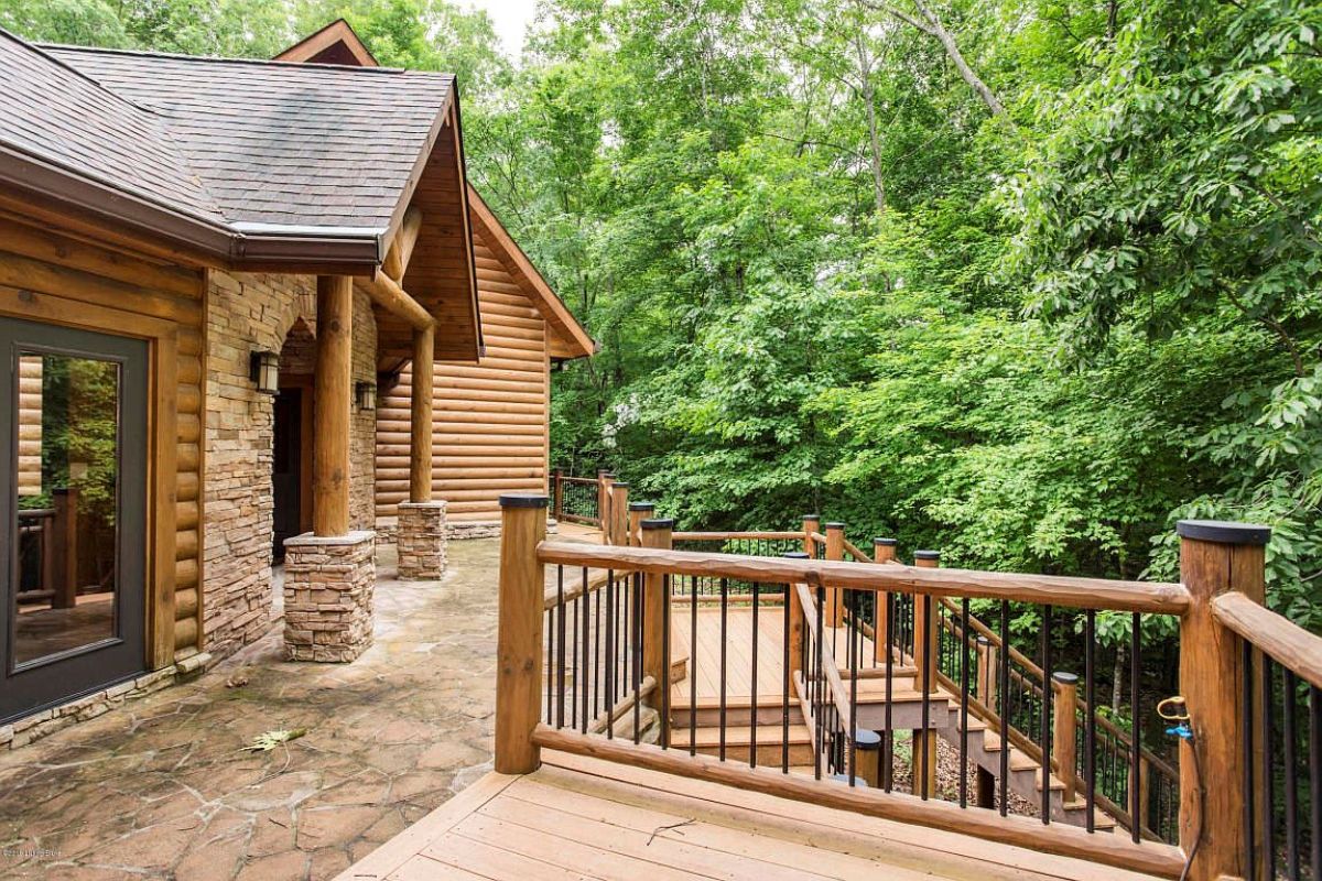 view across deck of log cabin with wood railing